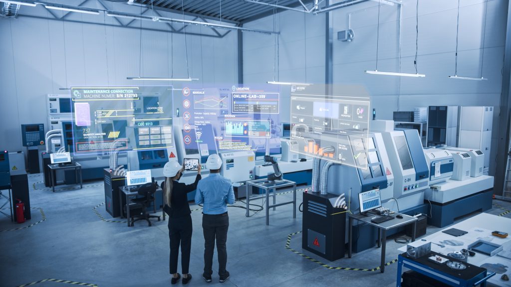 Industry 4.0 Factory: Two Engineers Uses Digital Tablet Computer with Augmented Reality Software to Connect with High-Tech Machinery, Robot Arm and Visualize Maintenance and Diagnostics of Equipment
